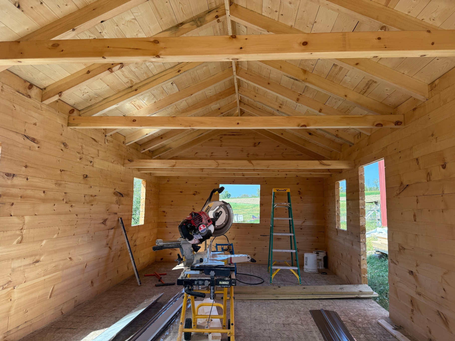 Interior framing of a Big River Cabin showing exposed roof rafters mid-build